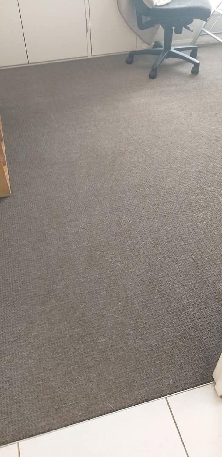 Commercial carpet in an office with a desk chair and cabinetry